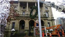 Hanging a large holiday wreath on a public building with a crane 5