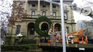 Hanging a large holiday wreath on a public building with a crane 4