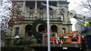 Hanging a large holiday wreath on a public building with a crane 3