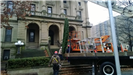 Hanging a large holiday wreath on a public building with a crane 2