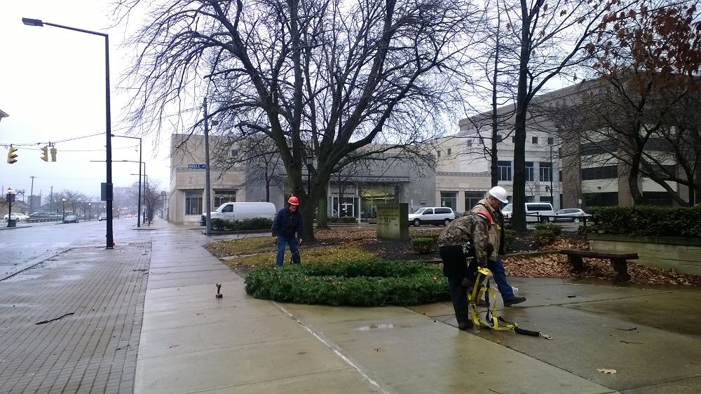 Picking up a large holiday wreath with a crane