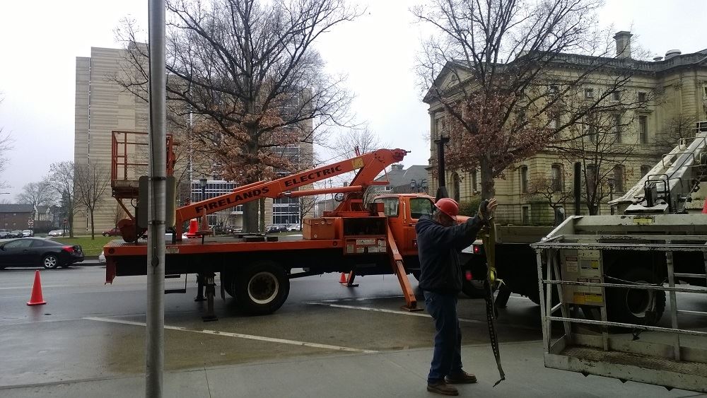 A cherry-picker truck marked Firelands Electric